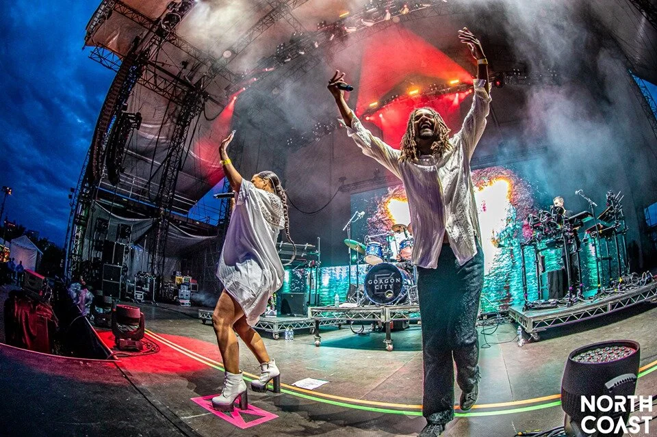 Photo By: Aaron Bradley. Gorgon City shows love to the crowd on the Pavilion stage.