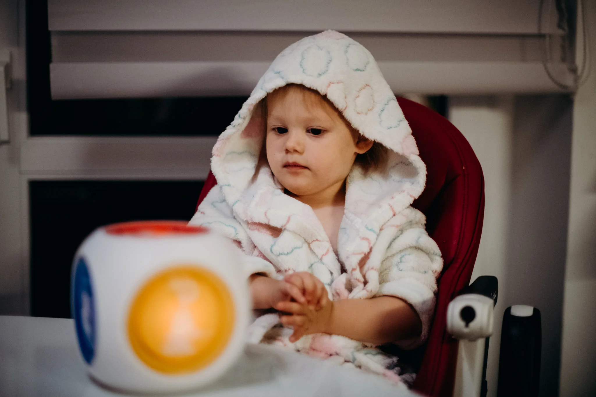 Another midnight wake-up. Leya enjoys a favorite one of her new/old toys while wearing a bathrobe.