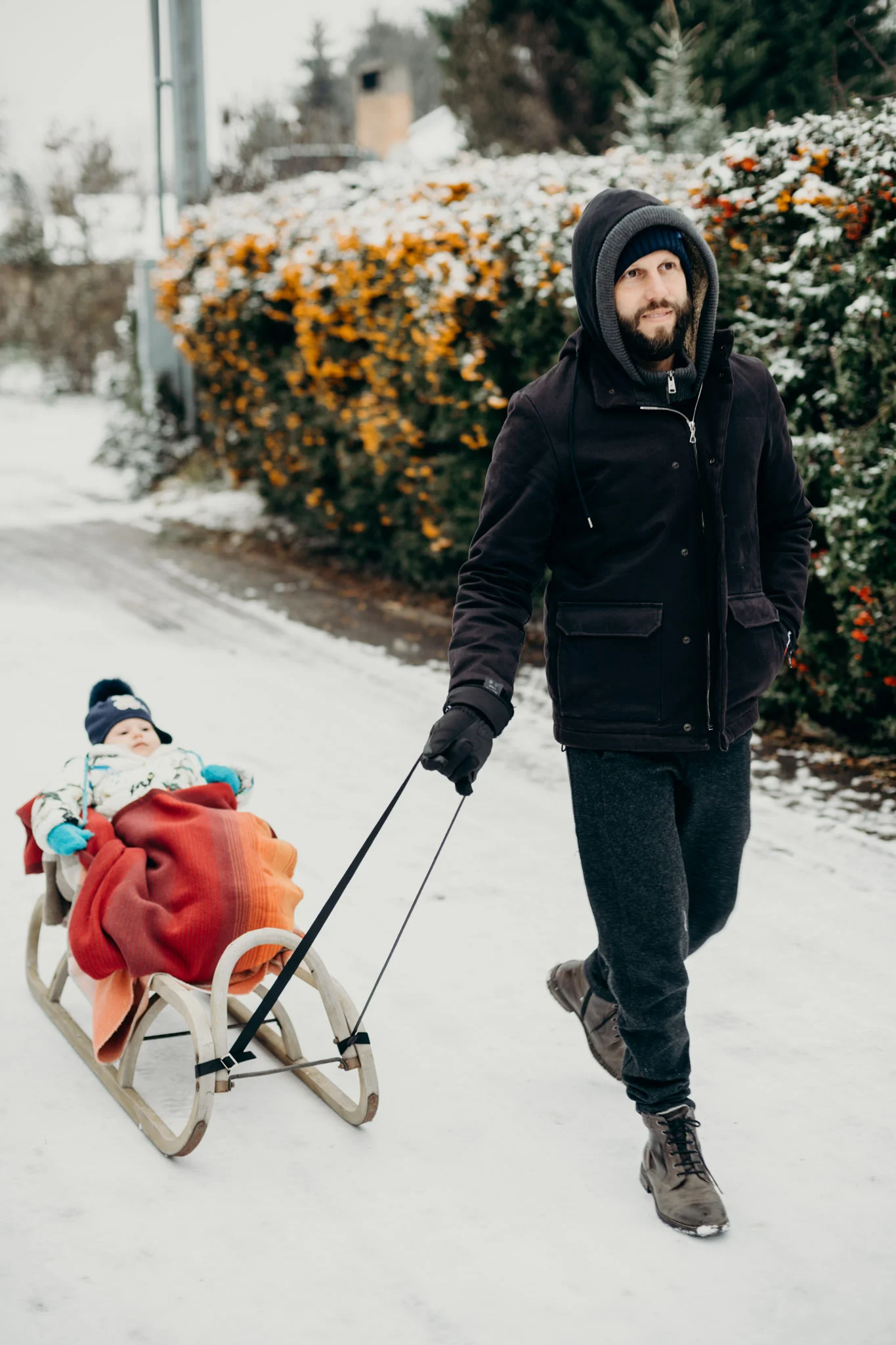 Leya gets to ride in a sled while we take a walk during our visit with Richie, Julius, and Anda. She doesn’t quite know what to think about it at first.