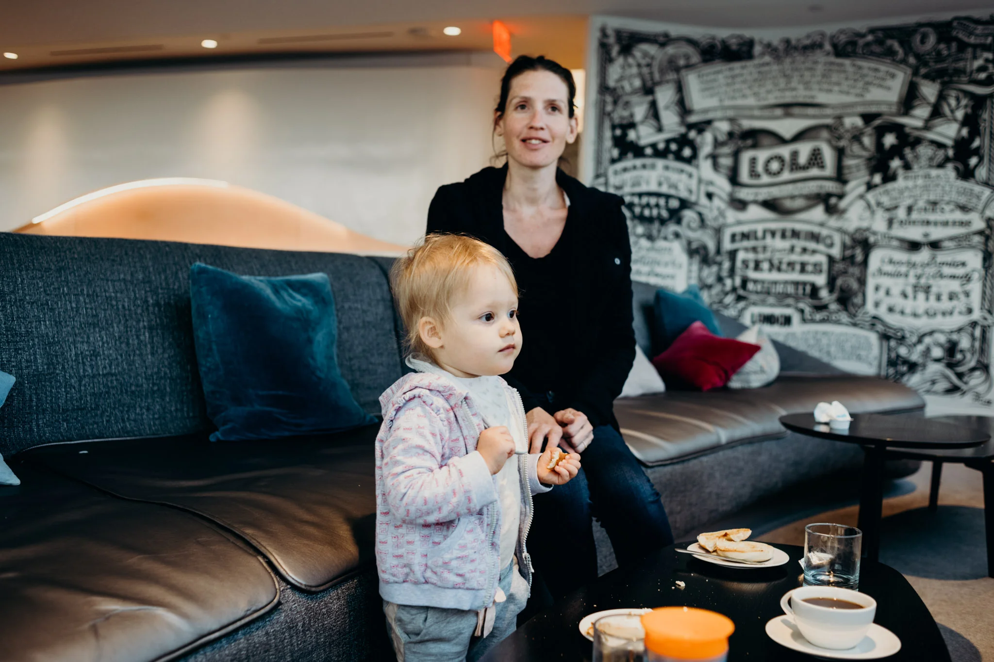 Leya and Sylvie have breakfast while watching planes land.