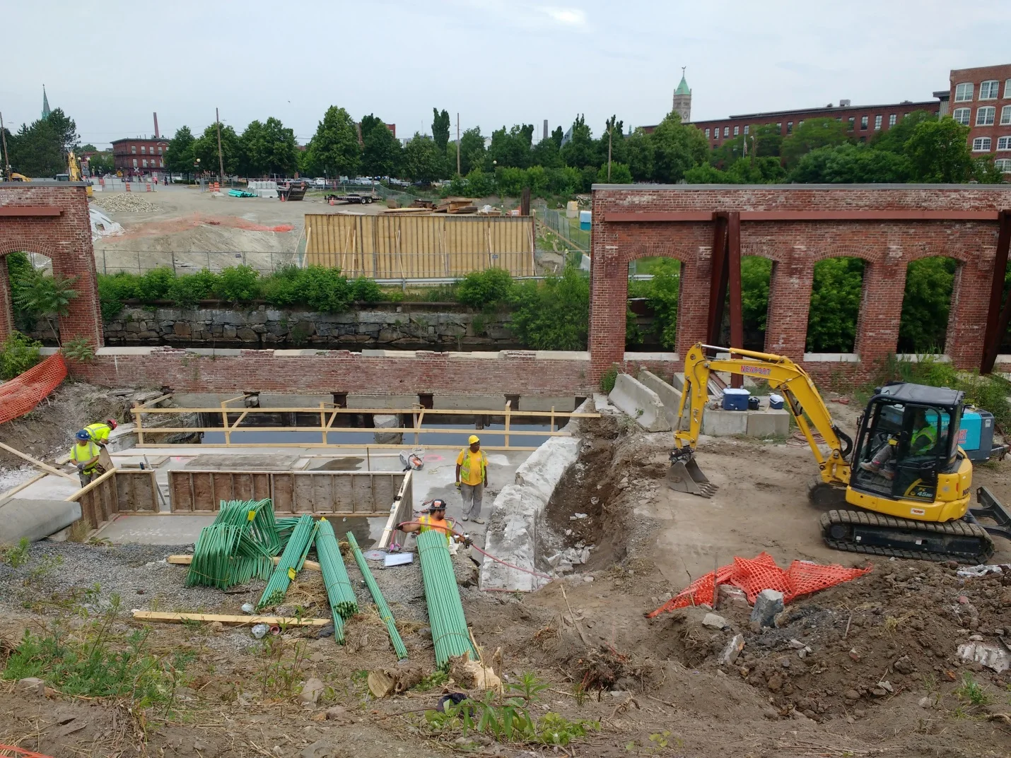 The wooden wall in the background is the form that concrete is poured into.