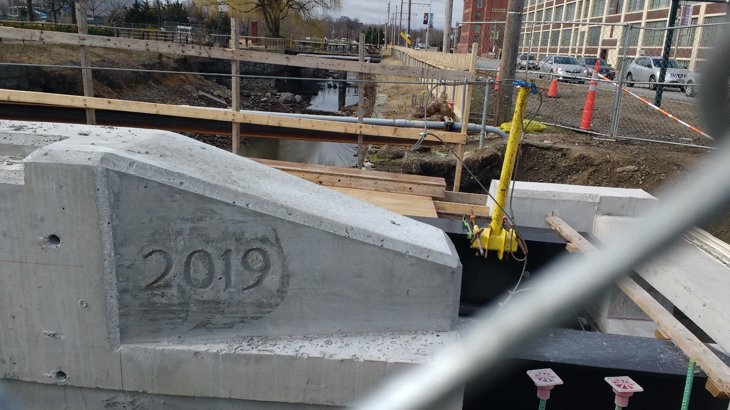 The concrete curb of the bridge leading into the Hamilton Canal Innovation District will soon have a steel crash barrier installed on top.