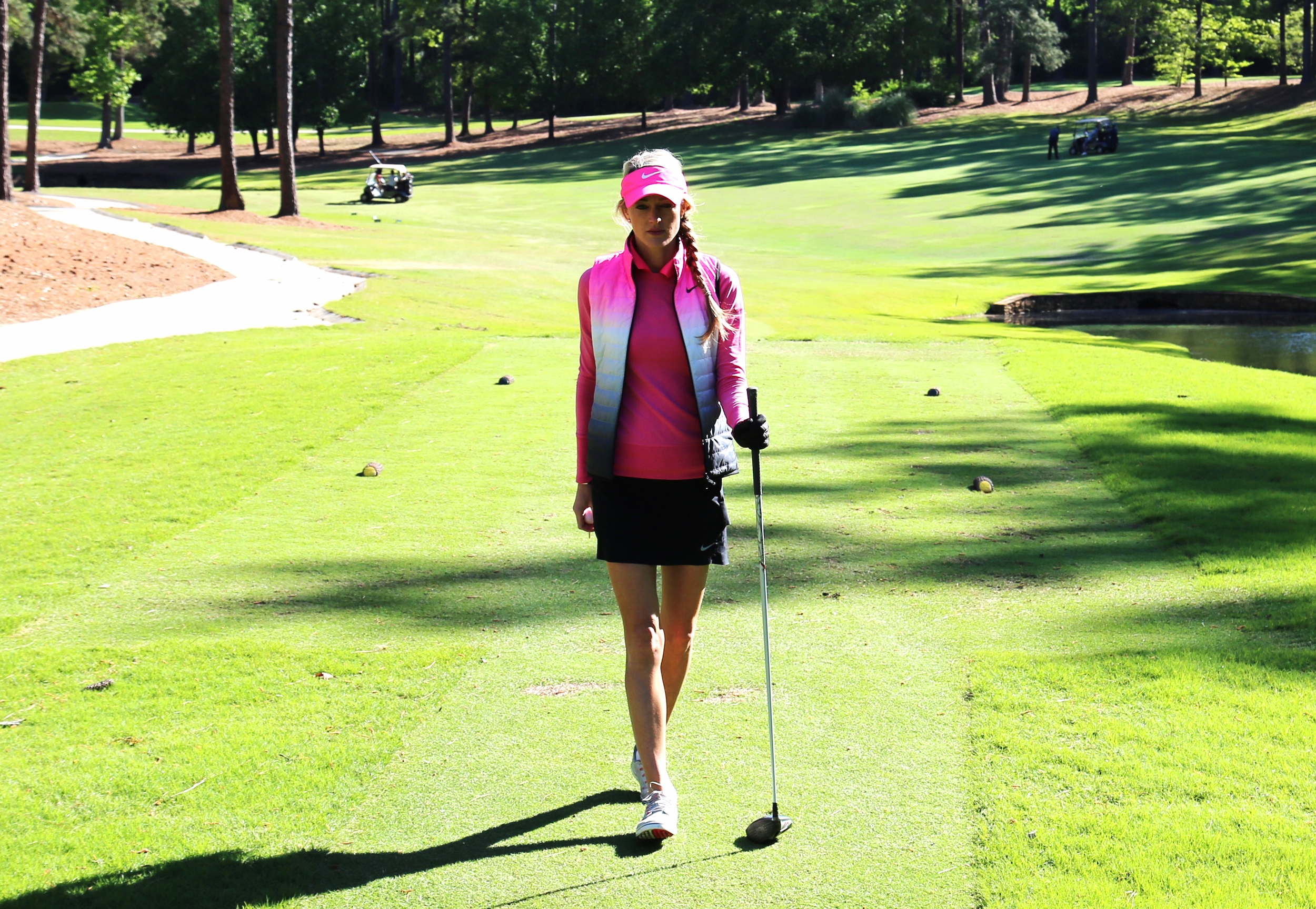 Sweater: Nike, Puffer Vest: Nike, Skirt: Nike, Shirt: Nike, Shoes: Nike, Hat: Nike, Club: Callaway