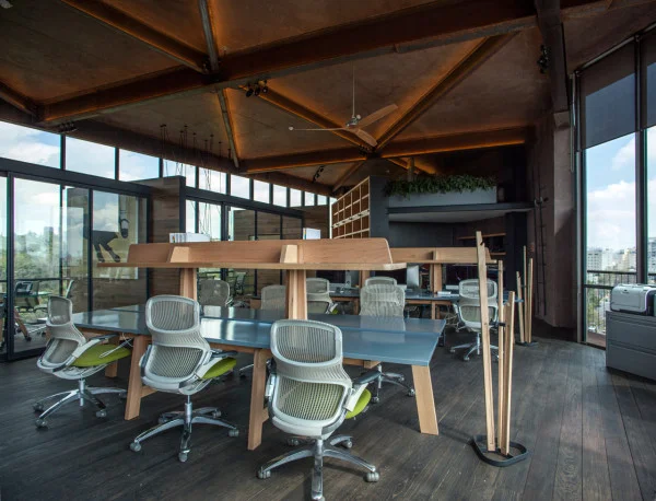 AN IRREGULARLY SHAPED OFFICE THAT SITS ABOVE THE TREETOPS