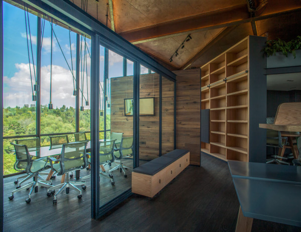 Wooden partitions and glass panels help divide the space without making it feel closed in or closing the spaces off.