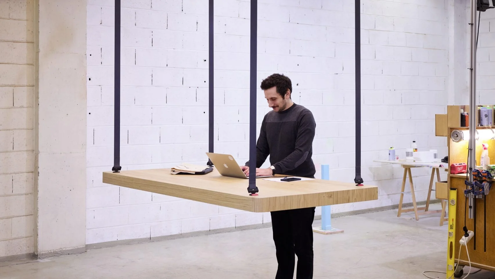 Flying Table by JCPCDR Architecture hangs from seat belt-style mechanism