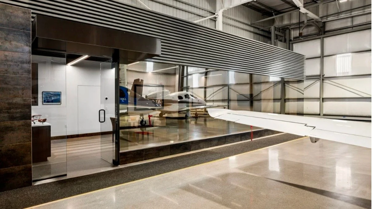 PRIVATE JET HANGER

&ldquo;Fly Me to the Moon&rdquo; &hellip;well maybe not that far but this lounge area created for this client and their guest is a great place to wait before you get to where ever you are going. Deep lounge seating and a kitchen f