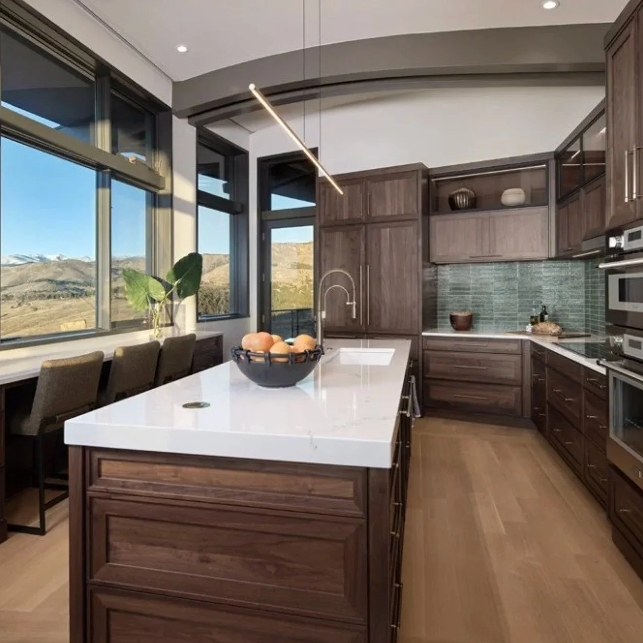 There's nothing more beautiful than walnut cabinets. Panel ready appliances allow more of the beautiful wood grain to come thru in this Boulder kitchen. @wood_mode @awakeninteriors #walnut cabinets #boulderdesigner