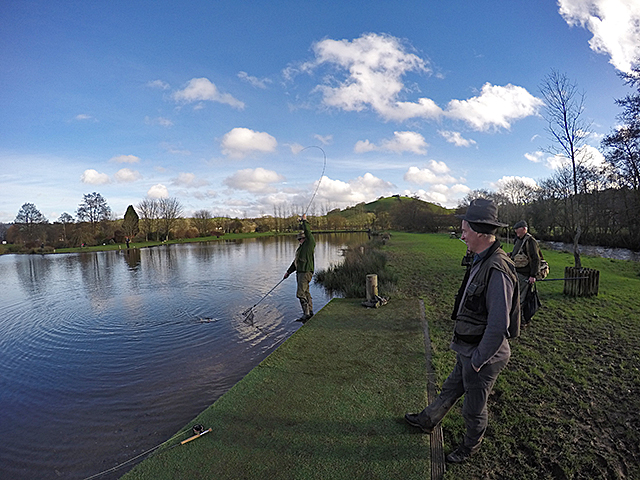 Nearly there! A crowd gathers to watch as Paul lands his big fish.