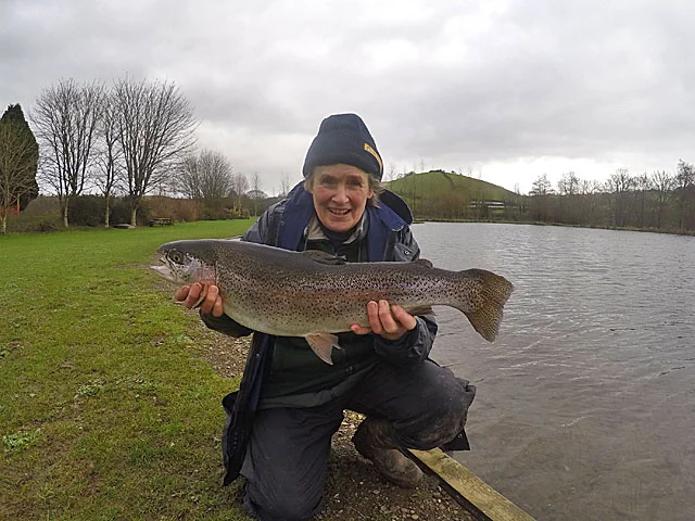 A very happy Rosie Coles with her 8lb 1oz Rainbow caught using a Flexi Black Zonker