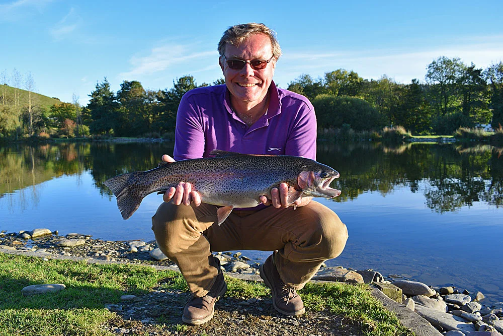 Just his third time fly fishing! John Hall from Bridgwater looks very happy with this stunning 7lb Rainbow caught on a Buzzer during glorious sunshine.
