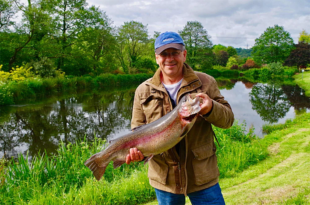 Neil Kyle with his 12lb 8oz Anchor Lake Rainbow Trout caught using a small bloodworm fly