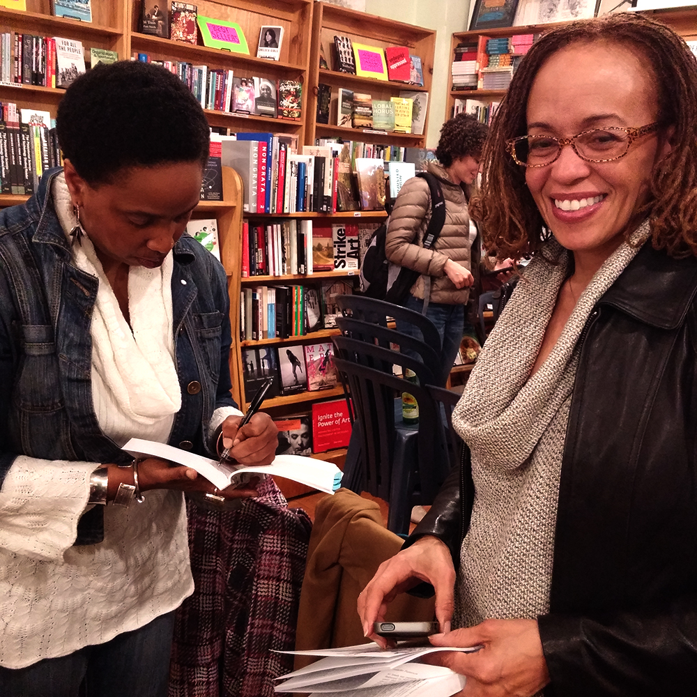 Aishah Shahidah Simmons signing author/editor Robin D. Stone’s (No Secrets No Lies: How Black Families Can Heal from Sexual Abuse) copy of Queering Sexual Violence Radical Voices from Within the Anti-Violence Movement. © 2016