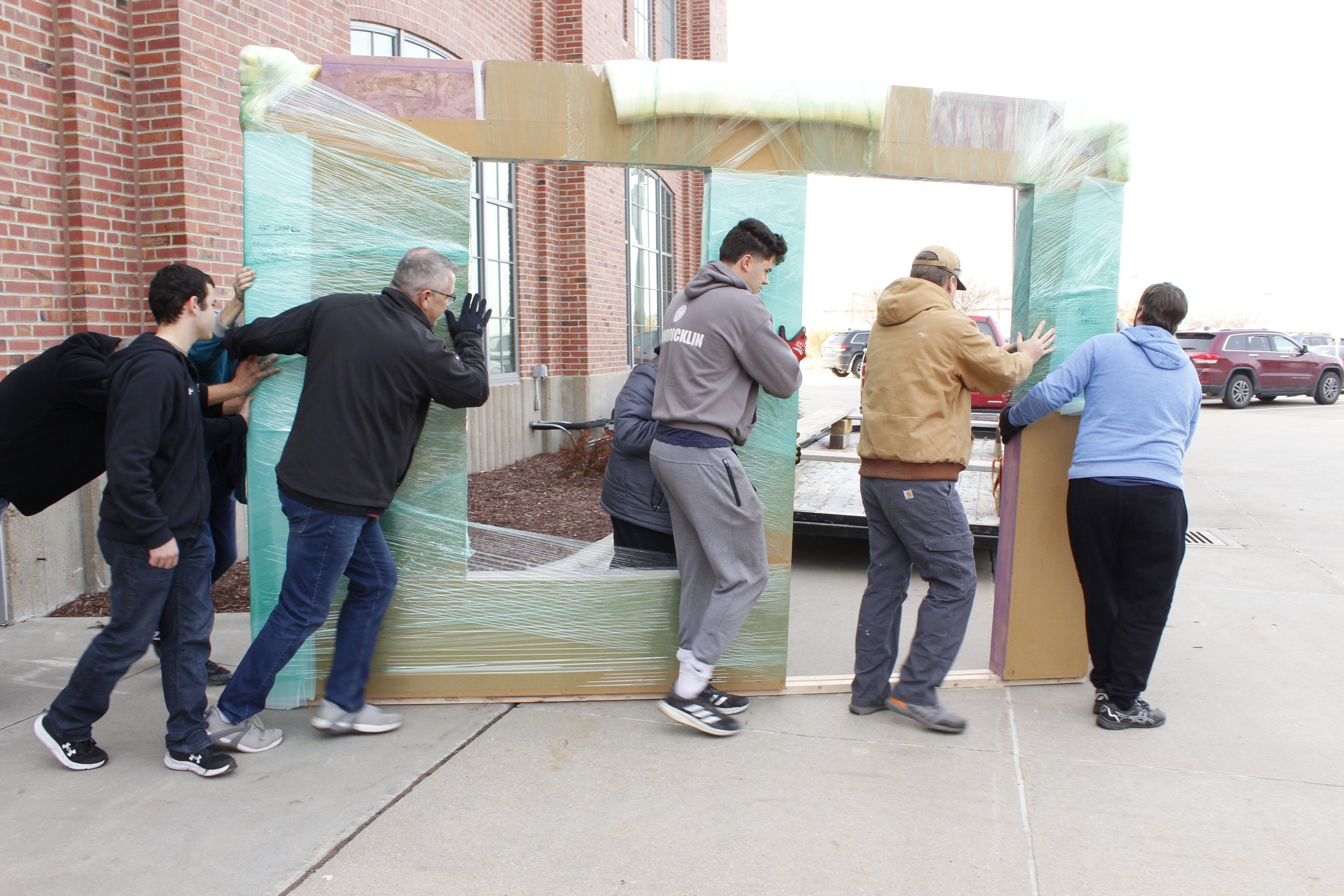  Volunteers joined their strength to move the Art Chapel’s rolling wall from UNL Innovation Studio, where it was constructed, to its new home at the Art Chapel. 