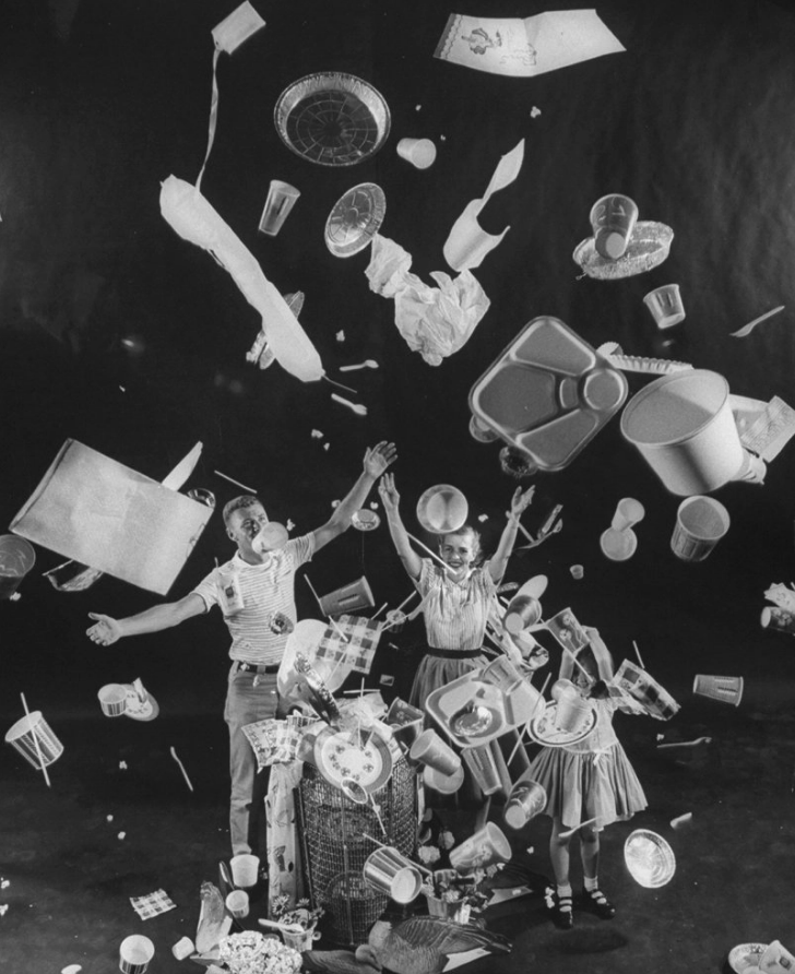 A man, woman and child toss "disposable" items into the air, 1955. Peter Stackpole—The LIFE Picture Collection/Getty Images