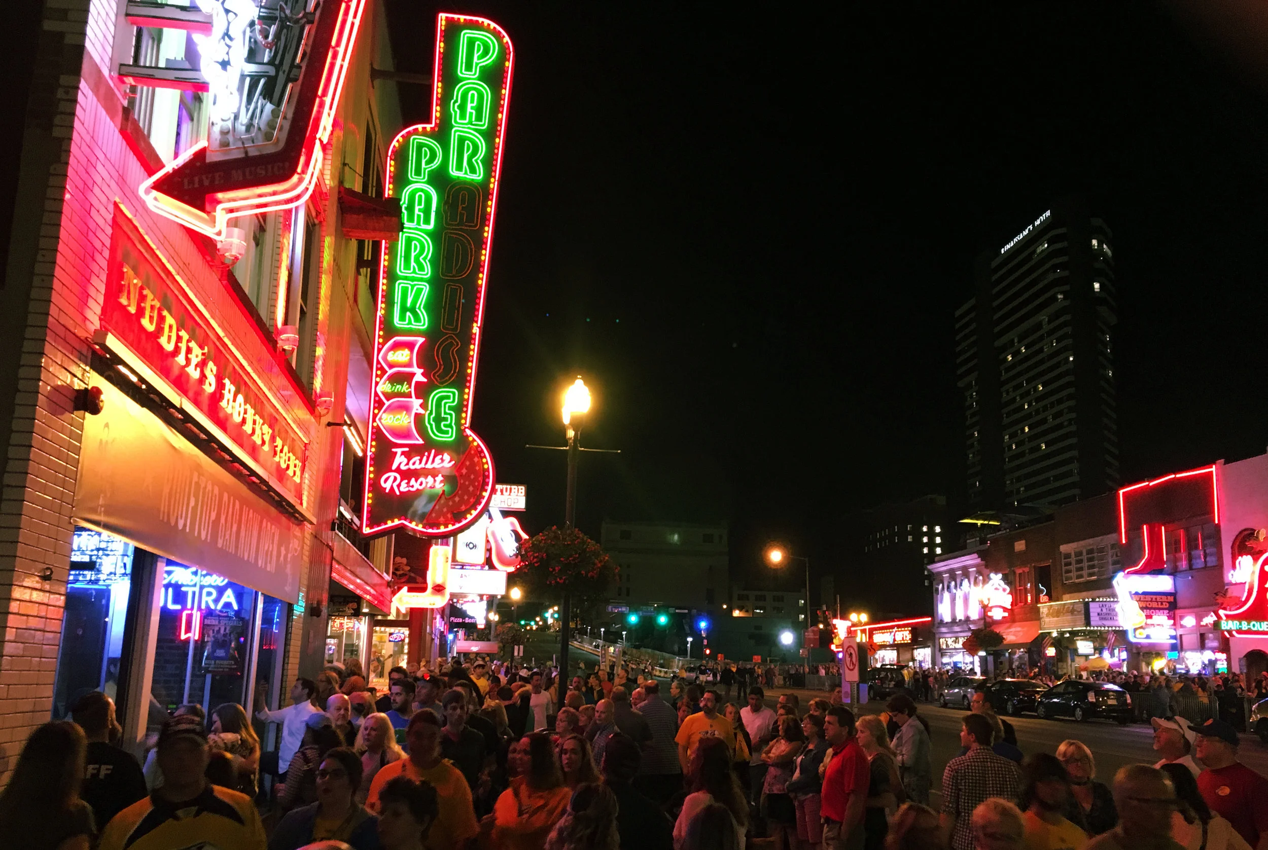 The crowd outside Paradise Park Trailer Resort on Lower Broadway in Nashville, TN watches the house band through the window from the street on Thursday, September 27th, 2017. The venue was filled to capacity, so people were forced to wait for someon…