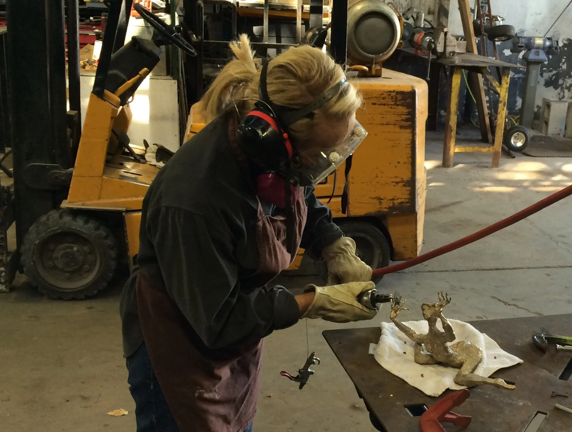 Removing all traces of the sprues with a pneumatic cutter.