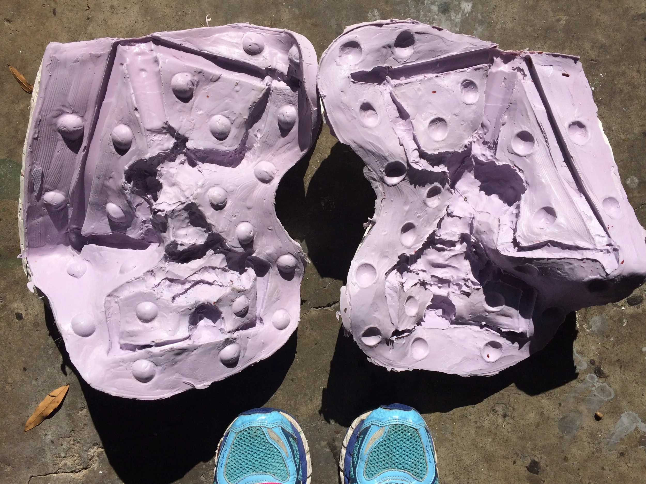 The first headstand mold opened. The dimples are registers to make sure the two sides are properly lined up. This mold includes the sprue system that would be used to get the bronze into the piece. 