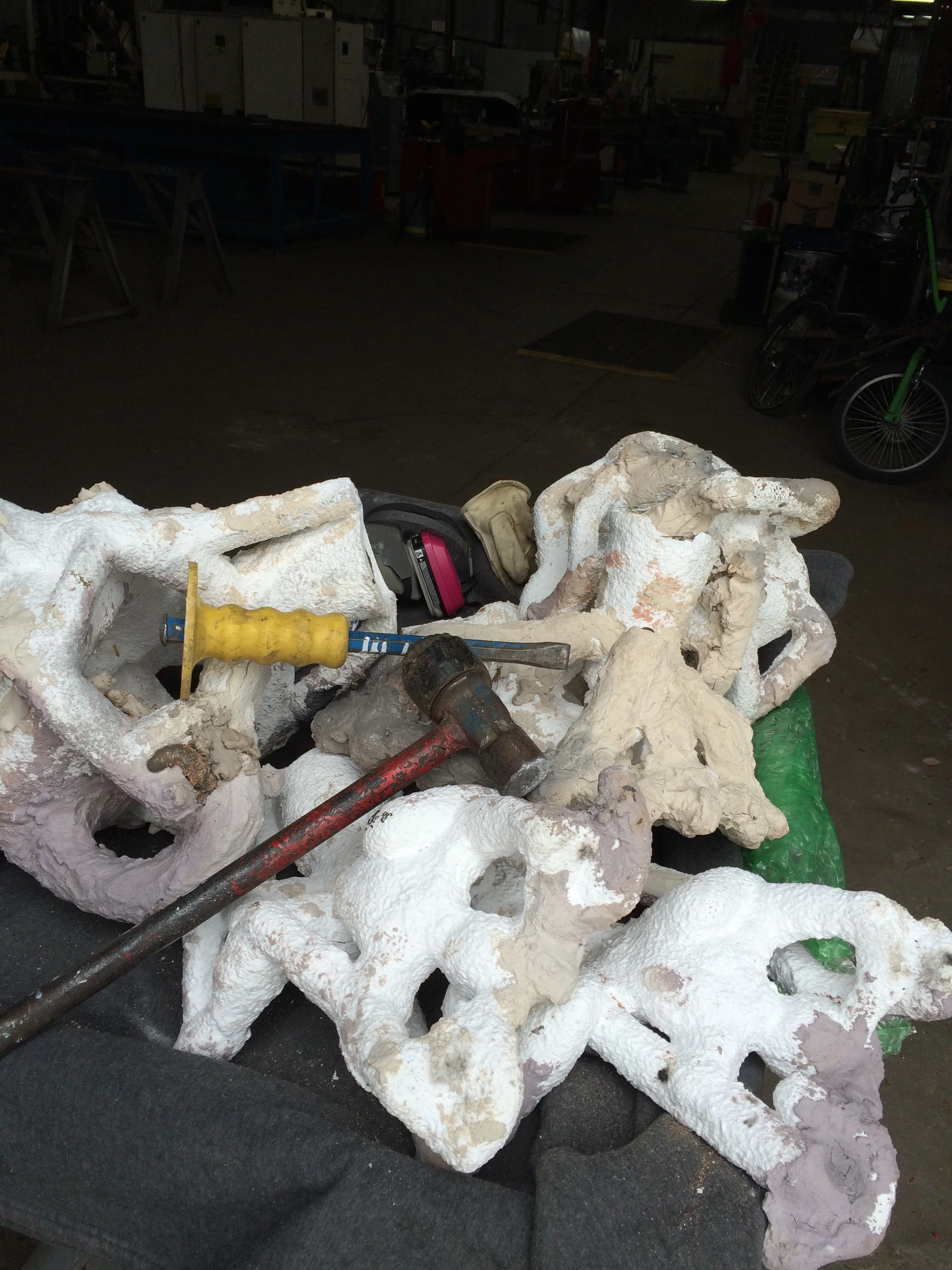 117 lbs. of bronze covered in ceramic shell that needs to be removed.