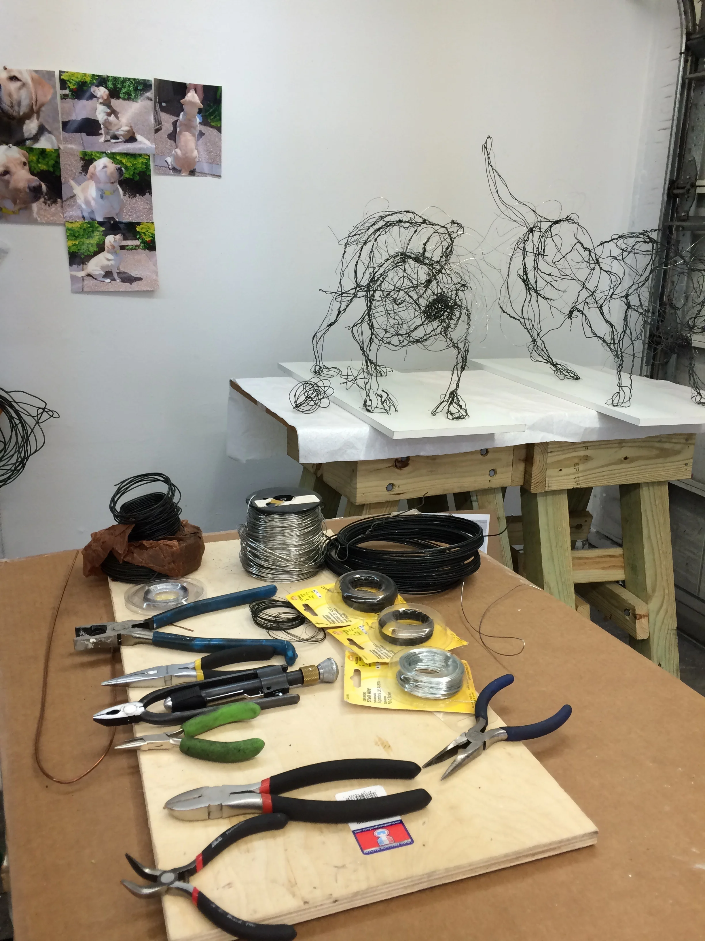shake shake shake -wire sculptures I and II in the background in the foreground are my pliars, wire cutters and assortments of wire. 