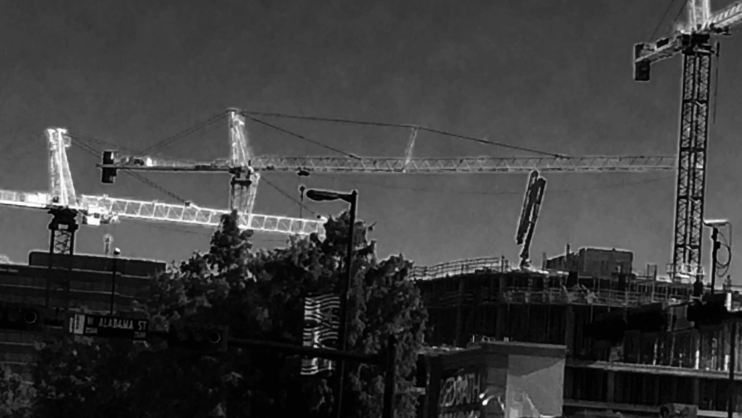 White construction cranes on Kirby drive. 