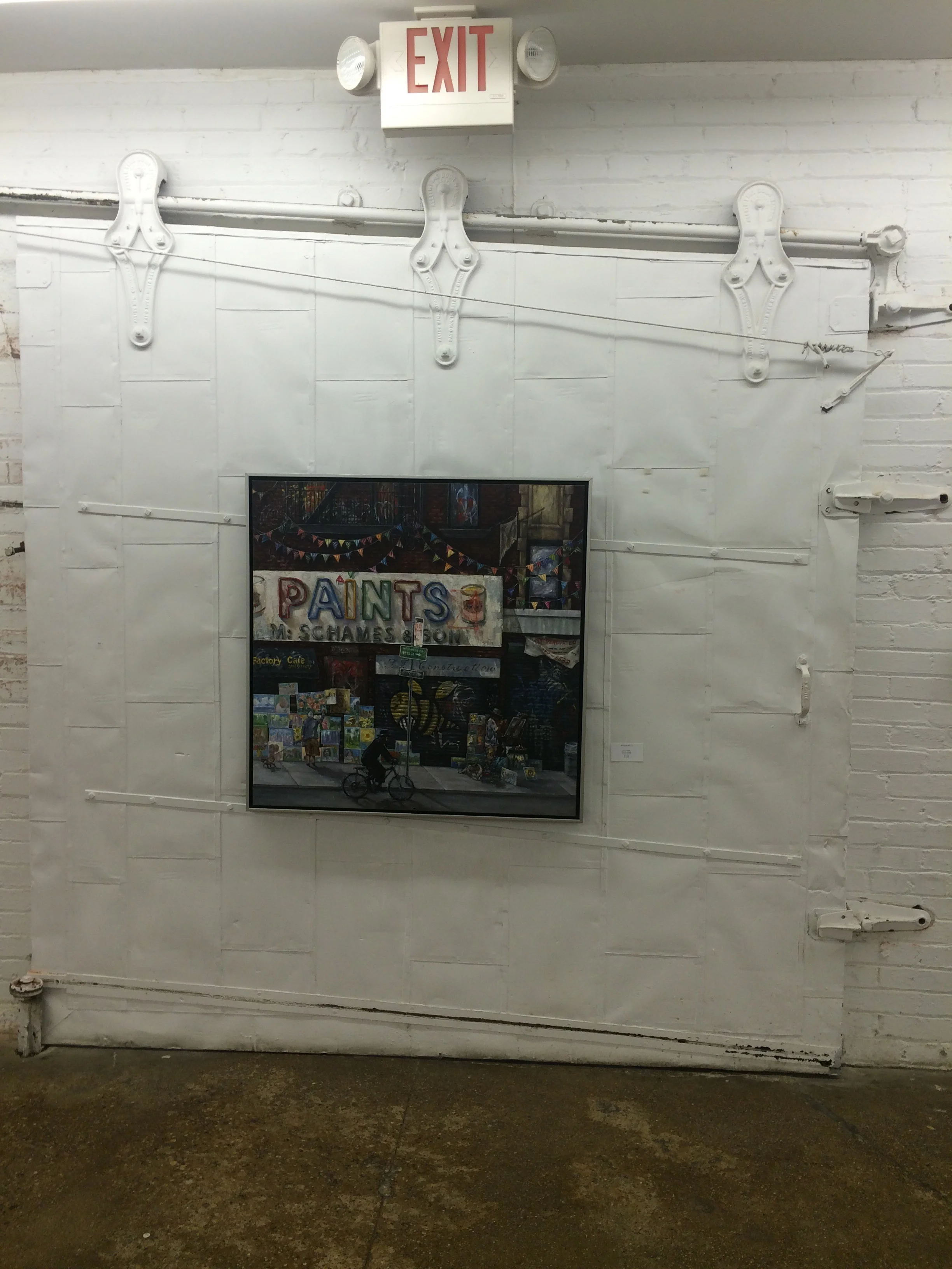 Industrial rolling doors used in the exhibit to hang a painting of a warehouse. 