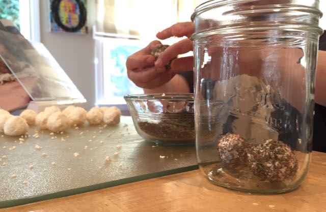 Dredge the cheeseballs in za'atar and place them in a jar.