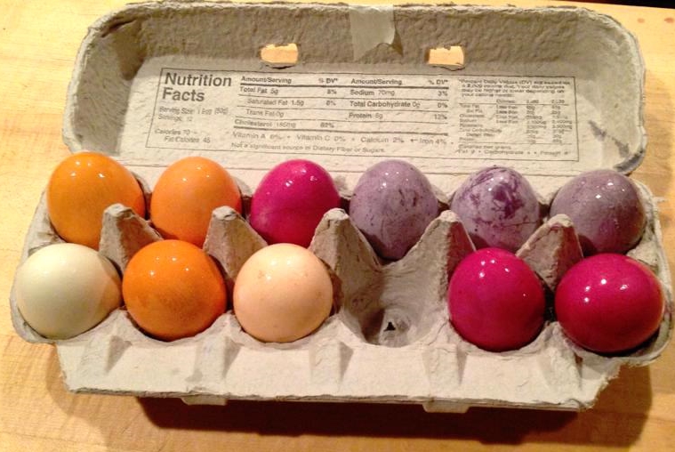 Yellow onion skin produced the orange, beets made magenta, and blueberries the variegated purple. On the end, one faintly green egg was from parsley, and the pale yellowish one was from cumin.