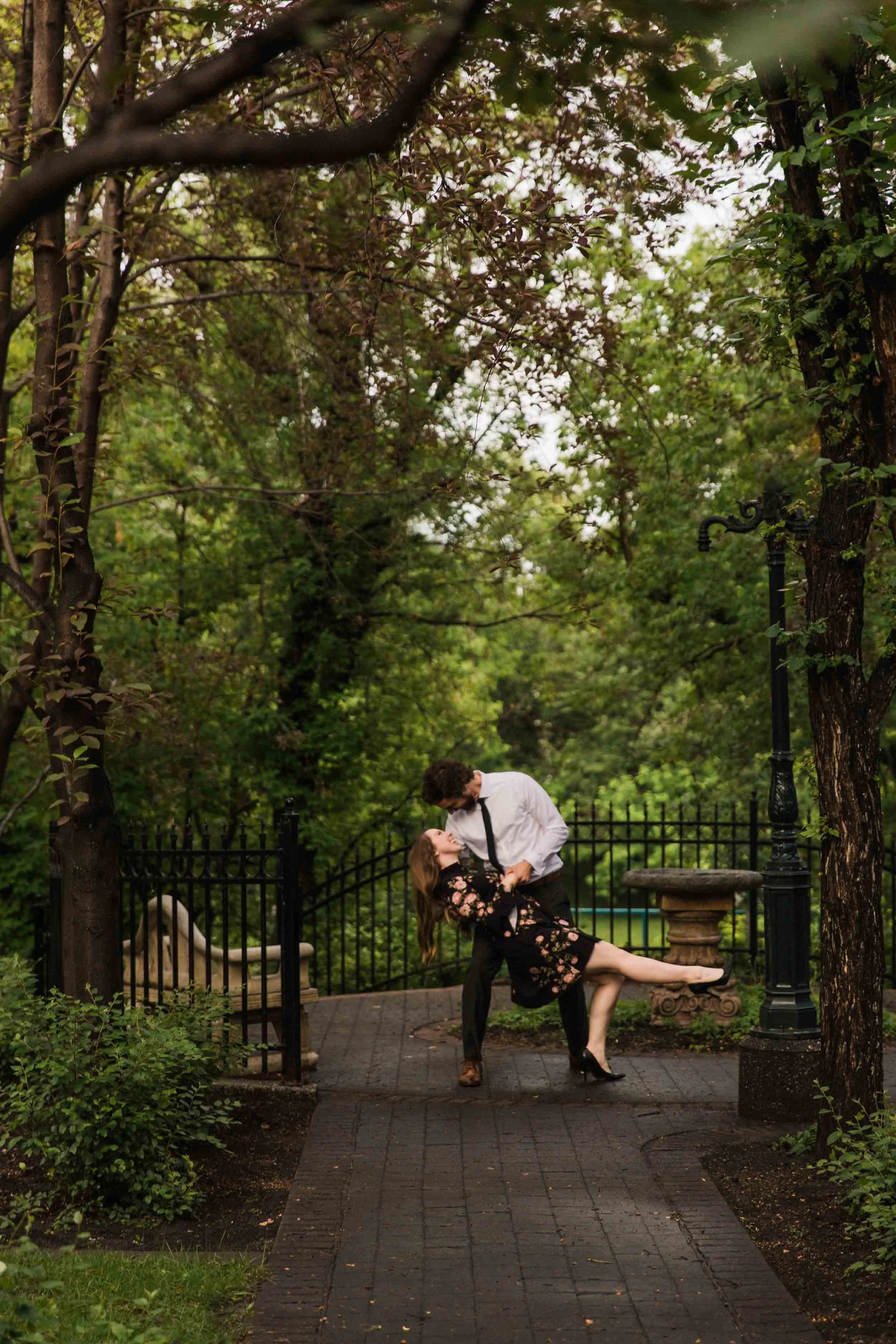Gerry Shaw Garden, Calgary, a couple dancing and cuddling beneath the trees