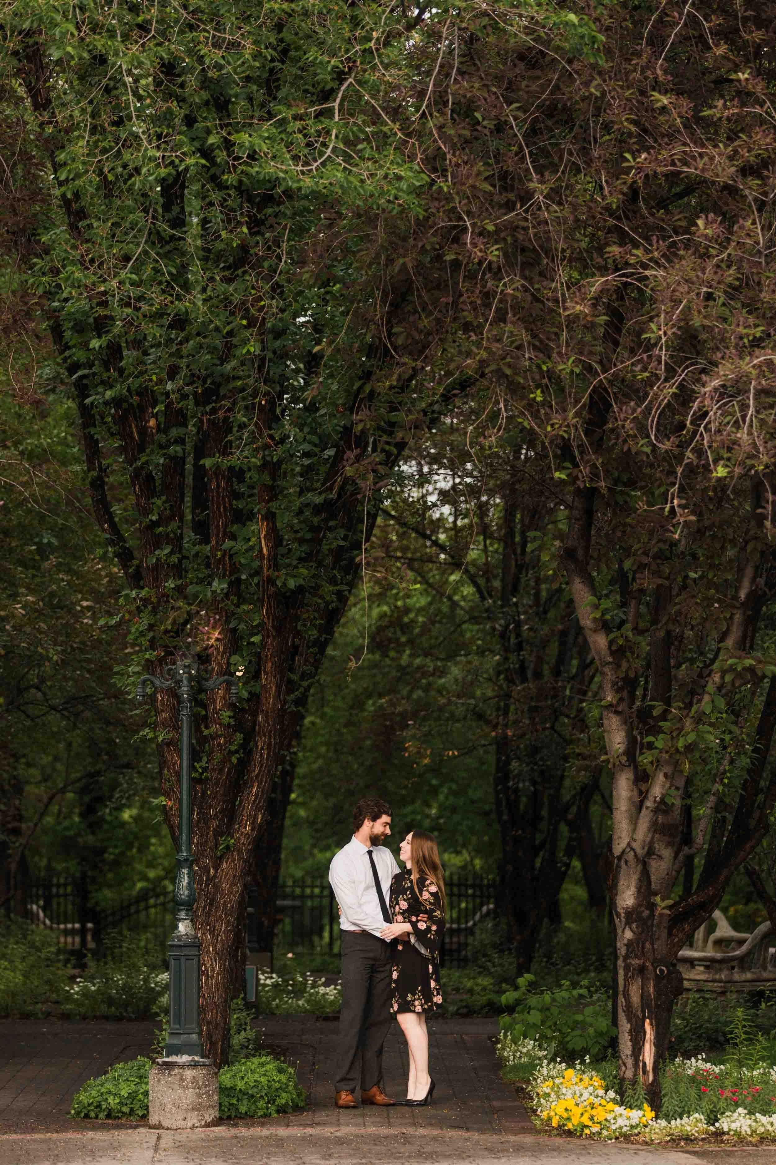 Gerry Shaw Garden, Calgary, a couple dancing and cuddling beneath the trees