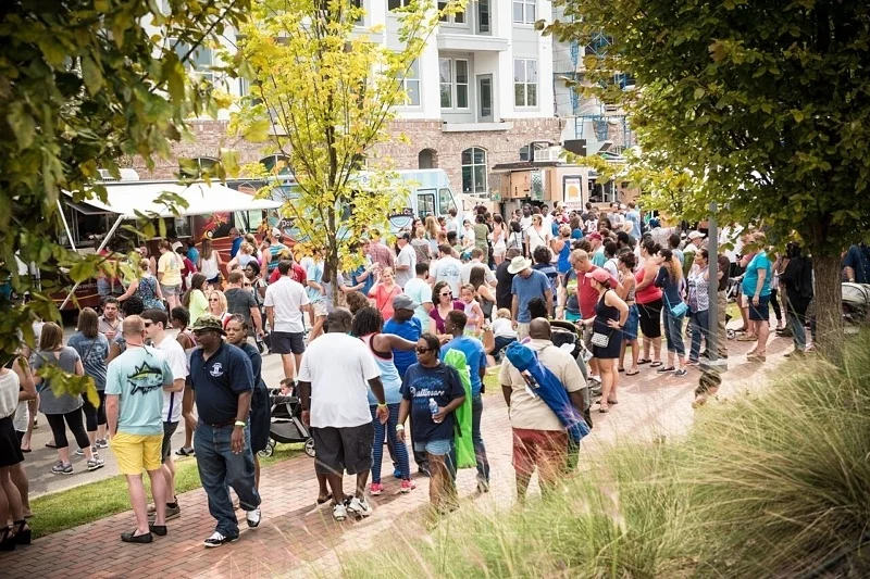 Locals swarm the street adjacent to the Park for Trucks by the Tracks, an annual food truck event and fundraiser for Railroad Park . Image: Railroad Park Foundation