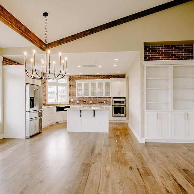 Favorite things about this kitchen: stainless steel, walnut floors, brick, white cabinets, those beams, that light... okay, I confess. I love all of it.