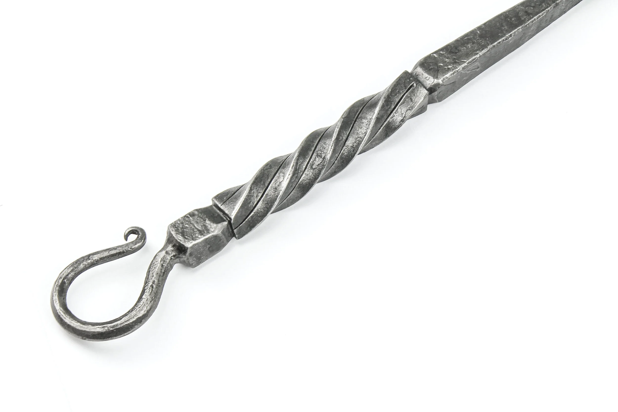Detail image of twisted metal handle on fireplace tools.