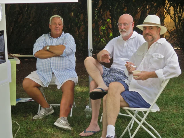 Kevin Kerr, president of the board, left, relaxes after a full weekend along with Michael Kennedy and Jack Burris. They were operating a photo booth, Greek style, at the Saturday dedication.