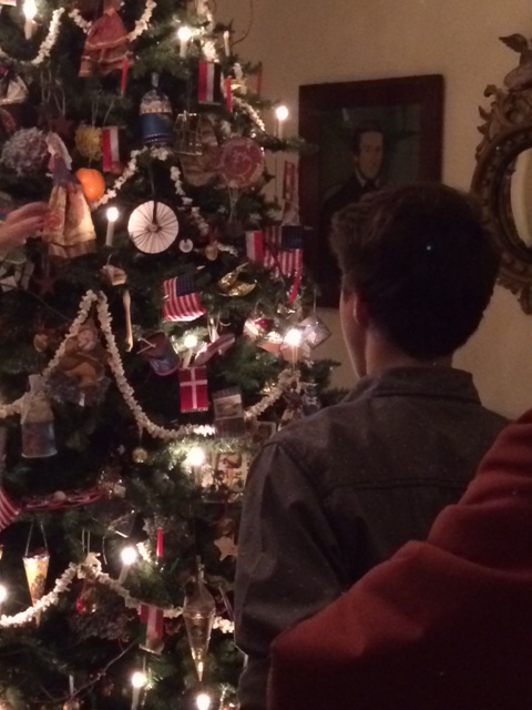A young boy admires the tree in the main parlor of the Robbins Hunter Museum during a Night Before Christmas event.