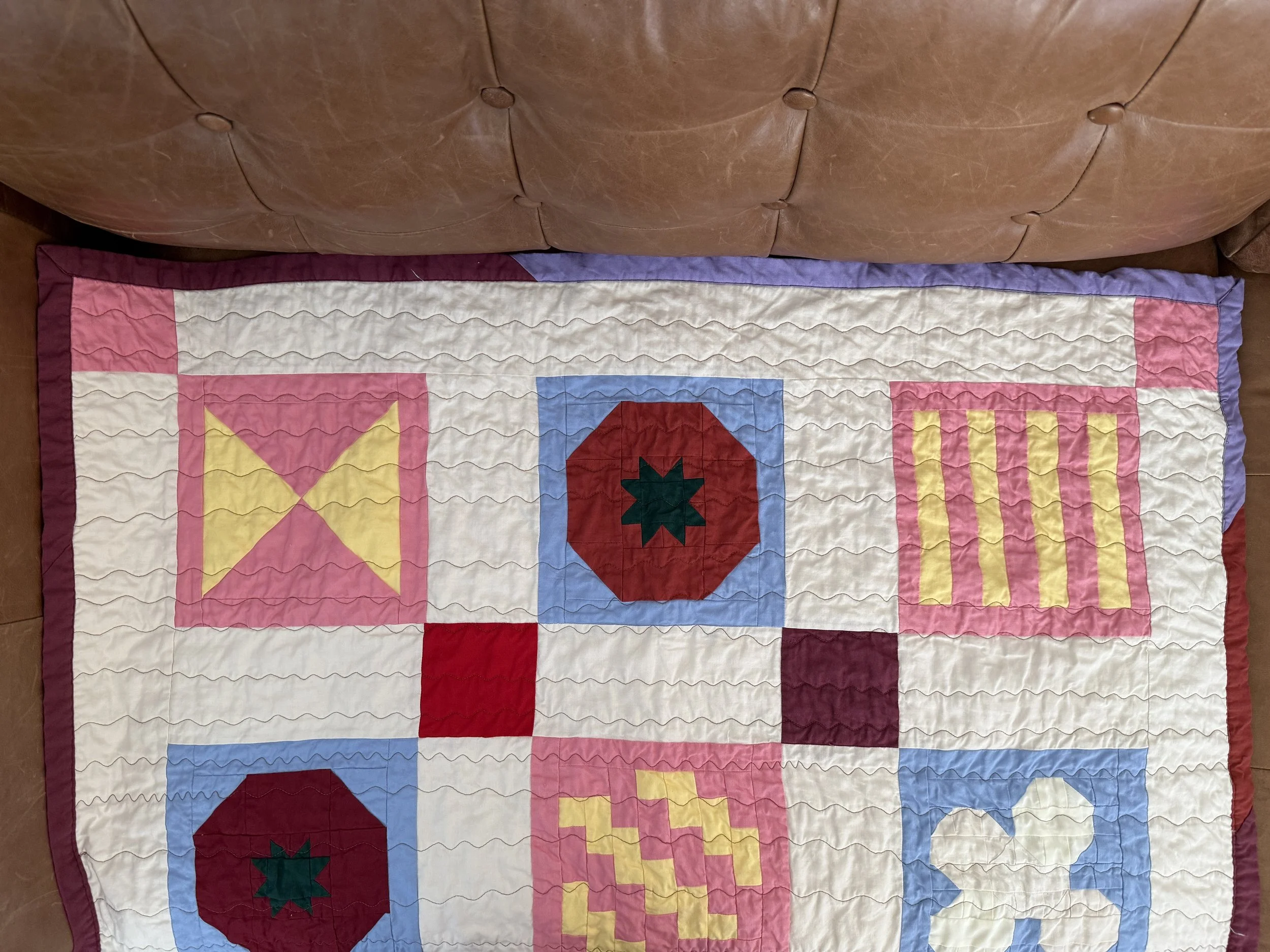 Close-up of the handmade tomato quilt block on the caprese pasta salad quilt