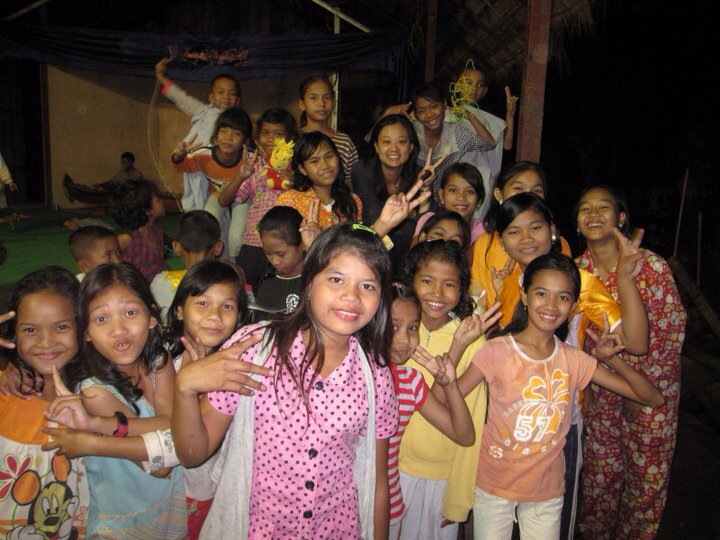 Carolyn (top, middle) with schoolgirls on a trip to Cambodia in July of 2011.