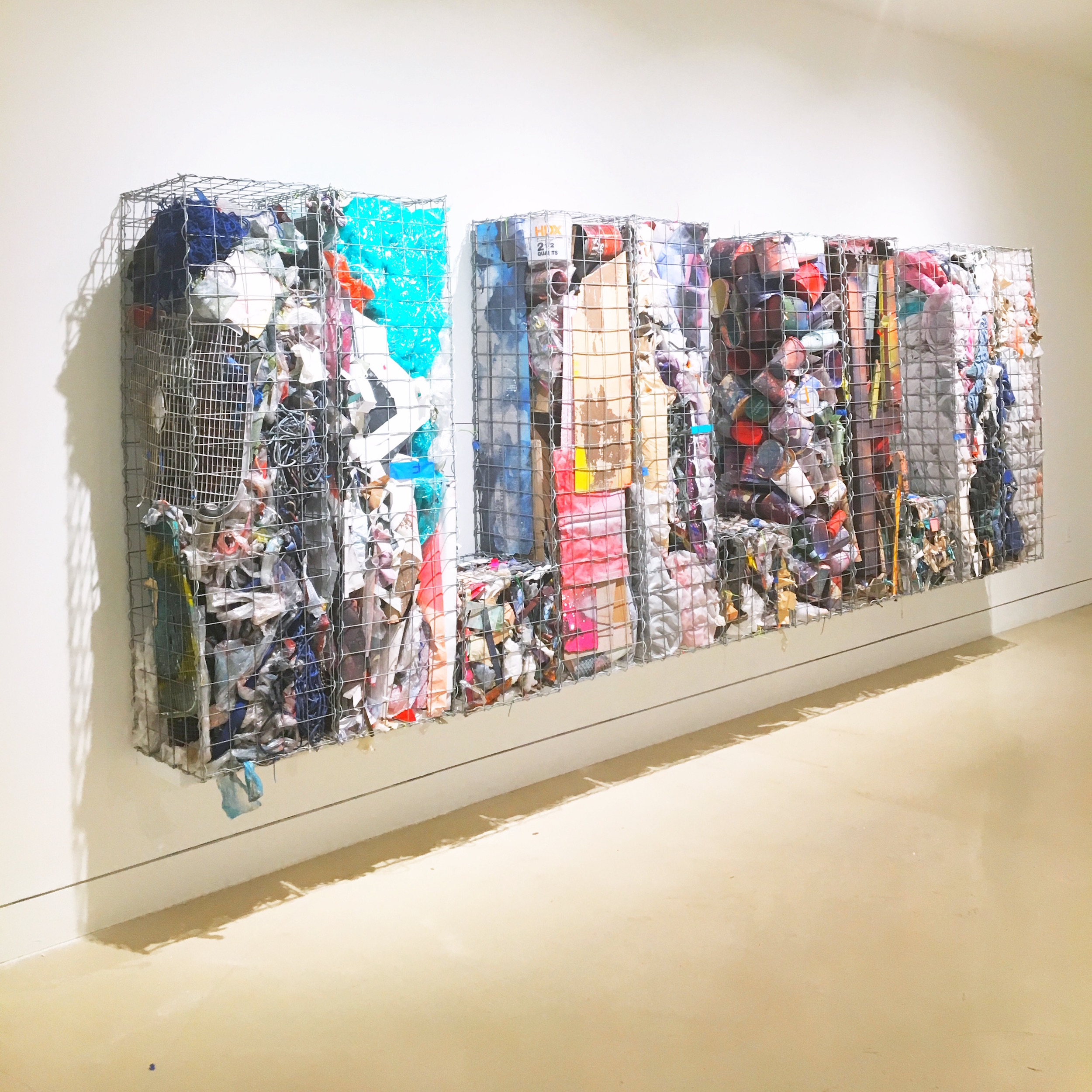  IAIN MUIRHEAD   18161:18172  , 2014-2018. Gabion baskets, zip ties, aggregate studio material. 60 x 174 x 16 inches. Installation view Torrance Art Museum. 