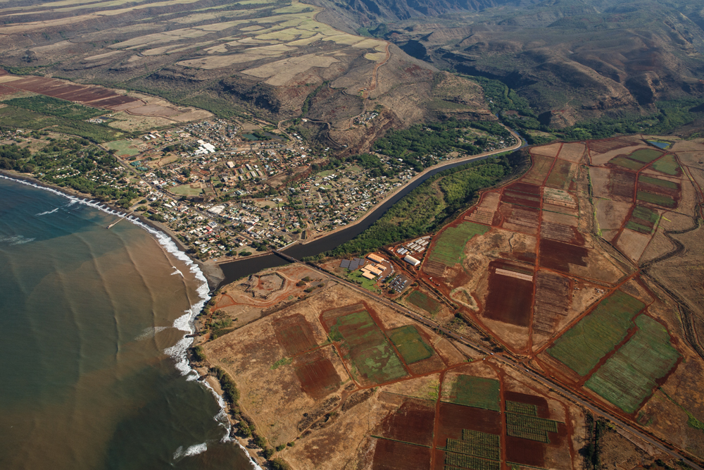 An aerial shot of GMO research fields upwind from the west Kaua`i town of Waimea. Photo credit: Makana Designs