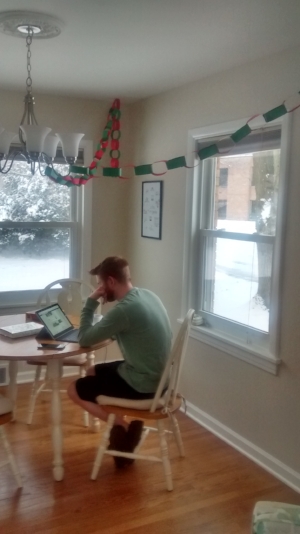 Andy is working while enjoying the snow and the paper chains. 