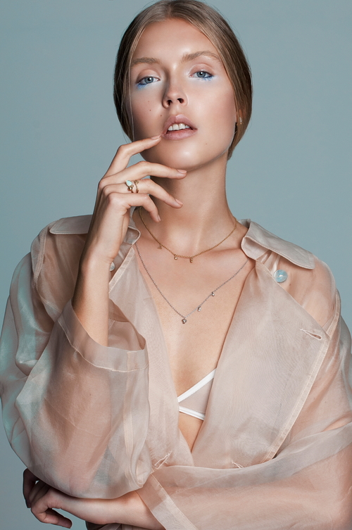 Charm Necklaces by Marina Antoniou via Courtesy of the Artist - Rings by Marina Antoniou via Courtesy of the Artist - Sheer anorak by Chalice