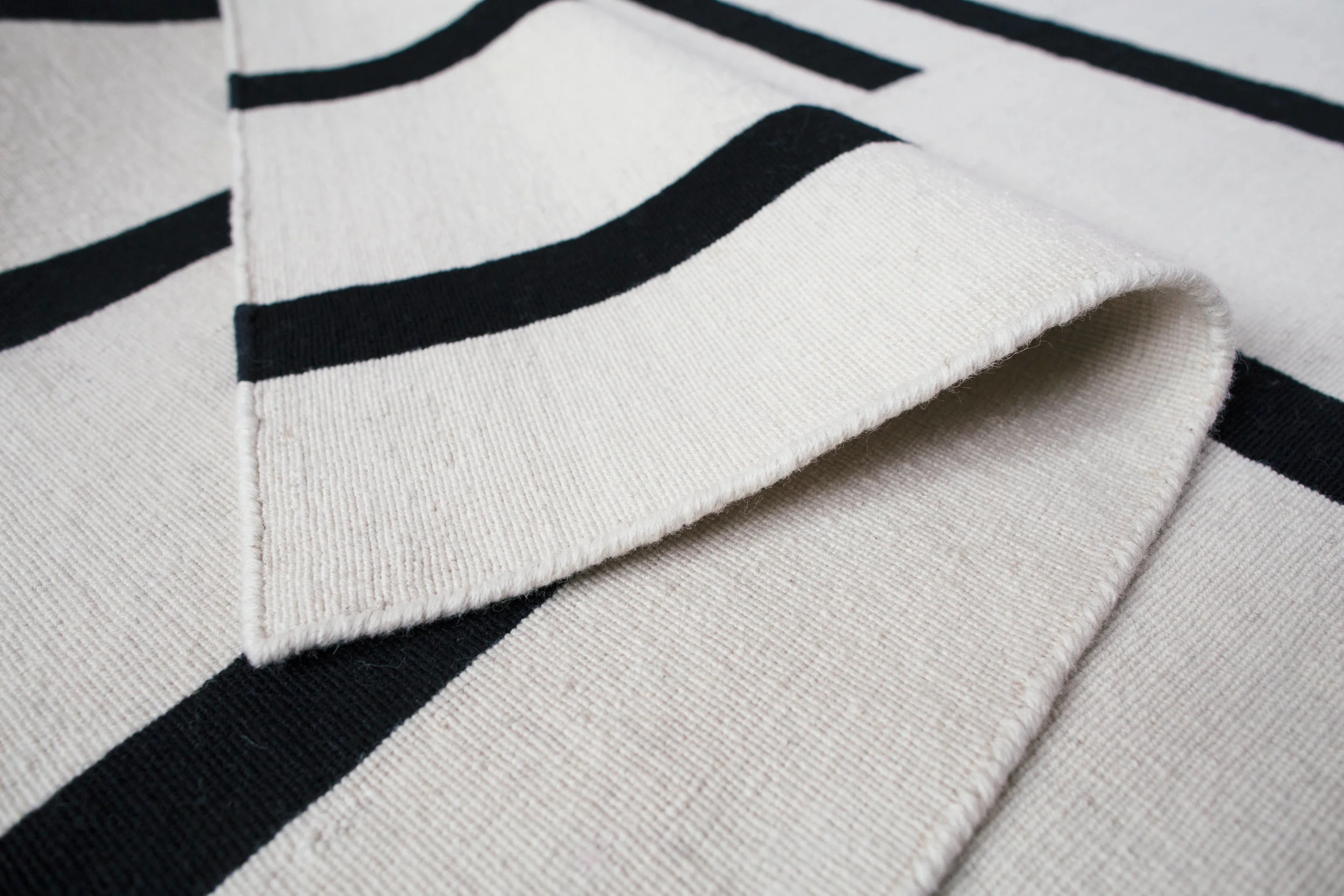 Tiger Cream/Black Hand loomed in 100% high quality wool.