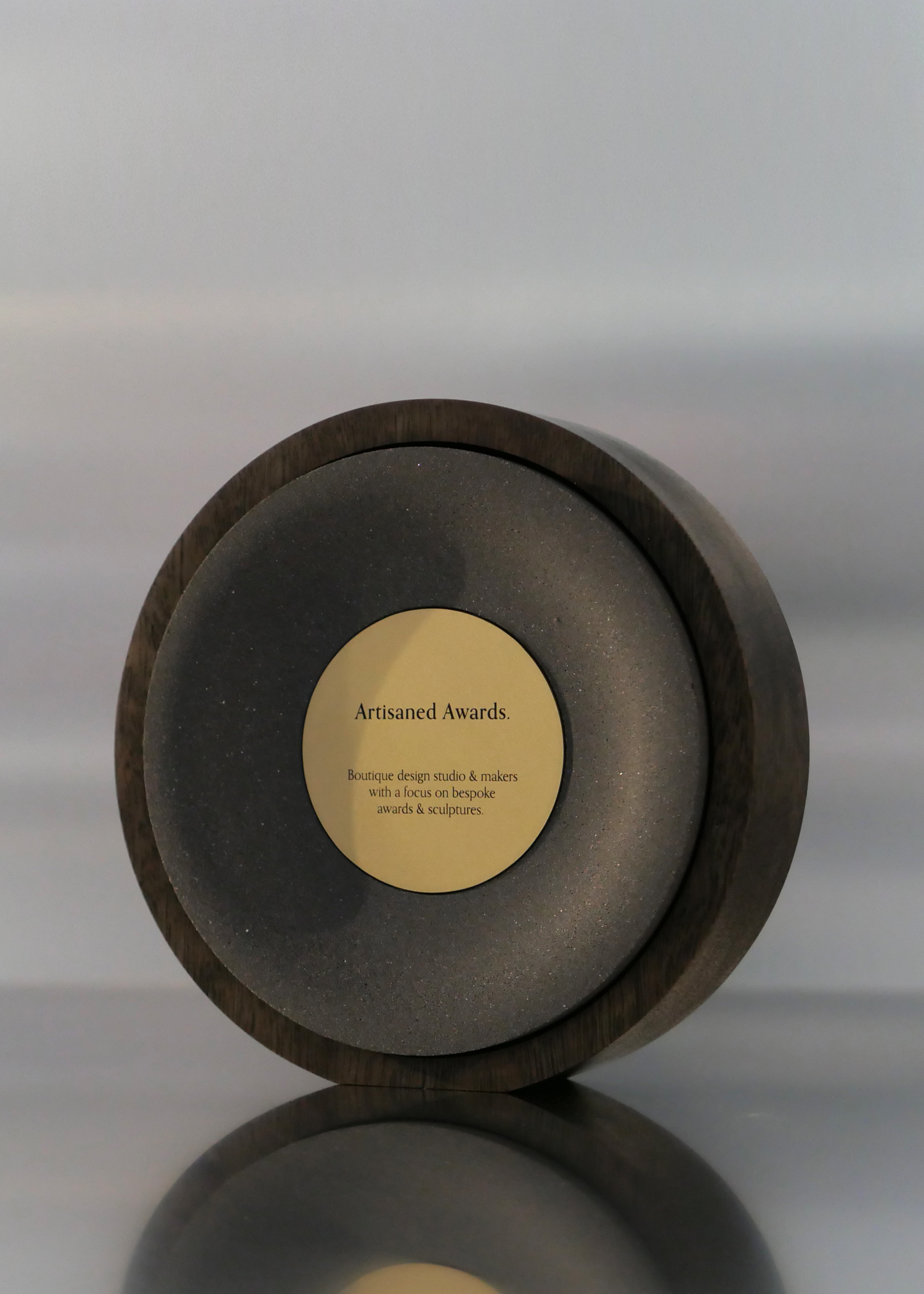 Arc award design, dark hardwood surround, charcoal core finish & bead blasted brass plaque.
