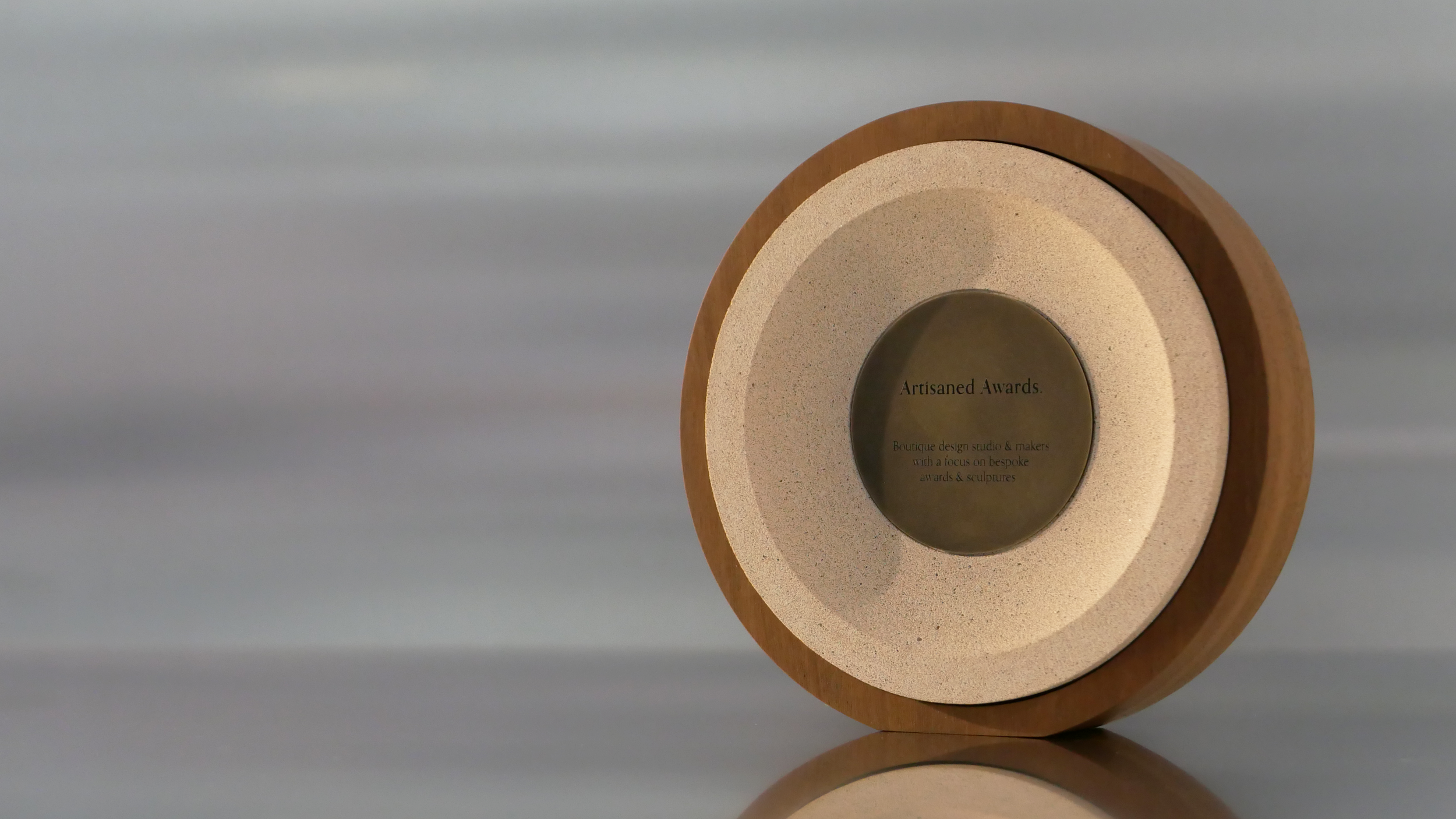 Sphere core design, light hardwood surround, terracotta light core finish & blackened brass plaque.