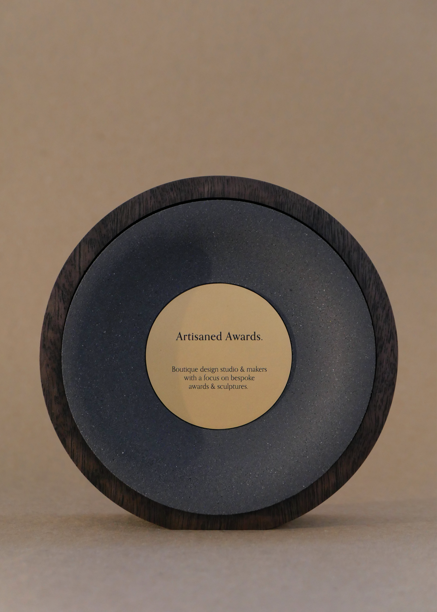 Arc core design, dark hardwood surround, charcoal core finish & bead blasted brass plaque.