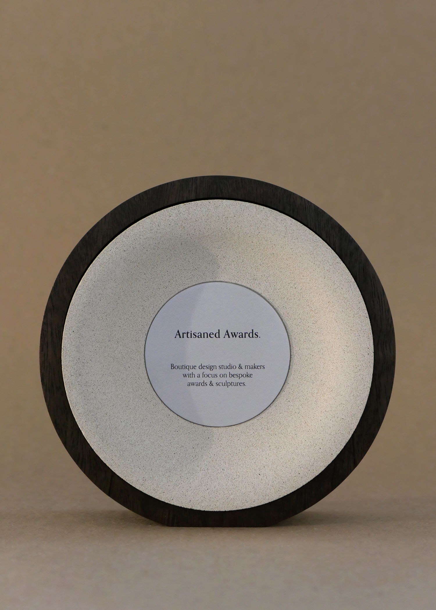 Arc core design, dark hardwood surround, beige core finish & bead blasted aluminium plaque.