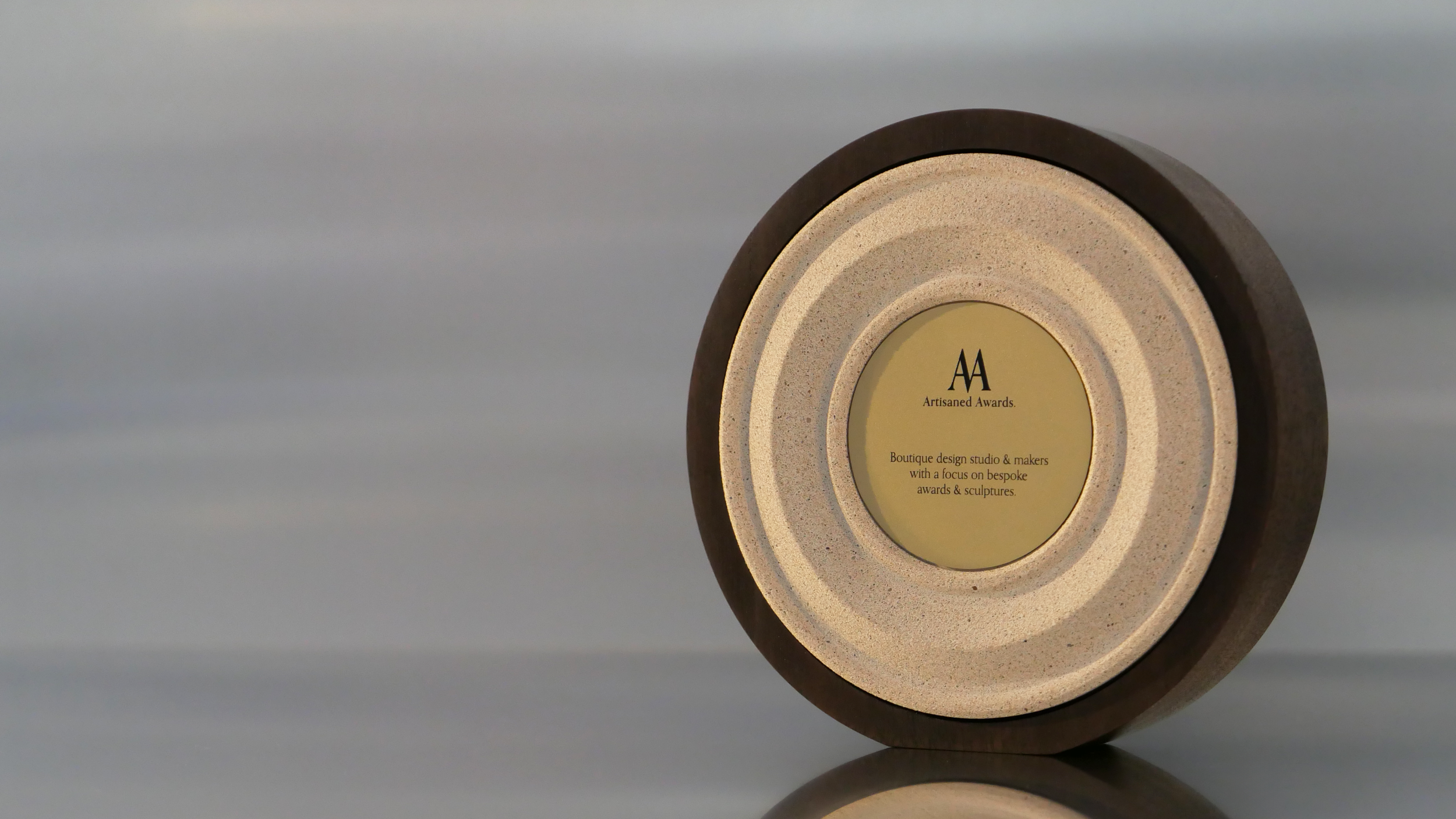 Amphi core design, dark hardwood surround, terracotta light core finish & bead blasted brass plaque.