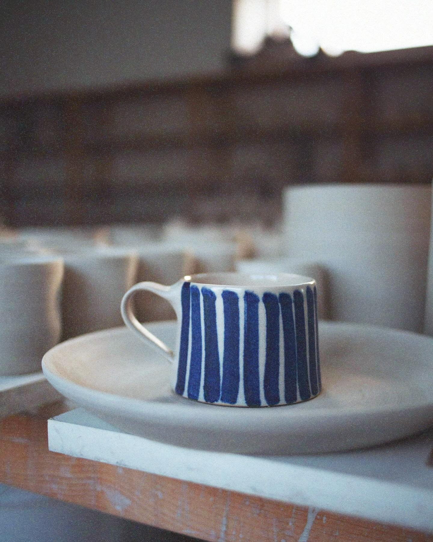 Studio blues as the sun sets over the studio.

I&rsquo;m spending my day glazing and applying cobalt wash stripes to boards of bisque fired pots. The sun is shining and the studio feels full of promise and excitement, with many pots beginning to line