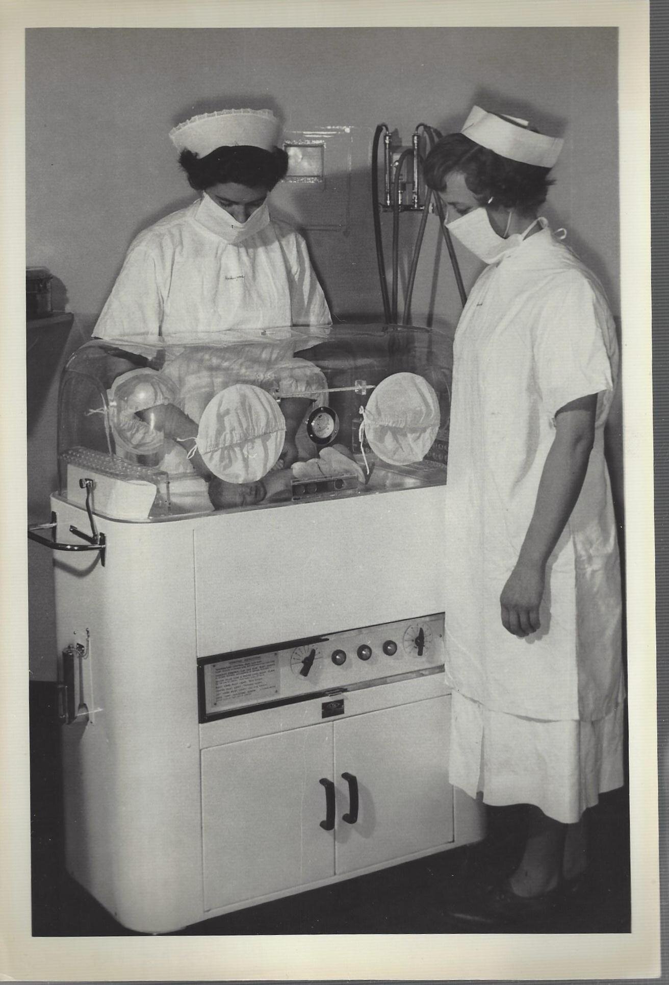 Nursing Staff with a Baby in an Incubator.