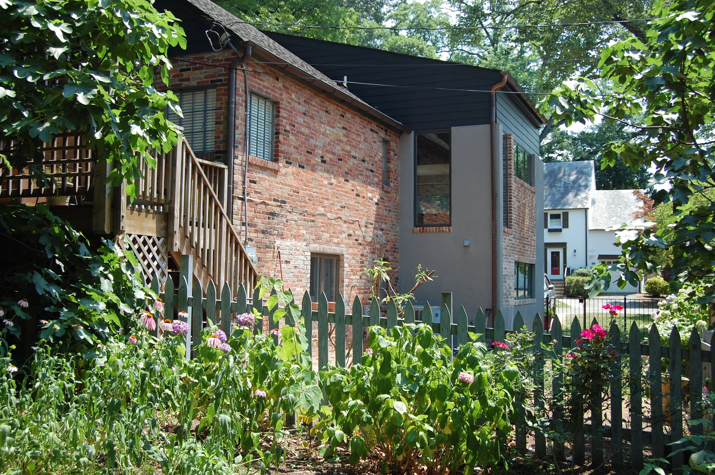 ADDITION WITH PARGED WALL AND REPURPOSED BRICKS 